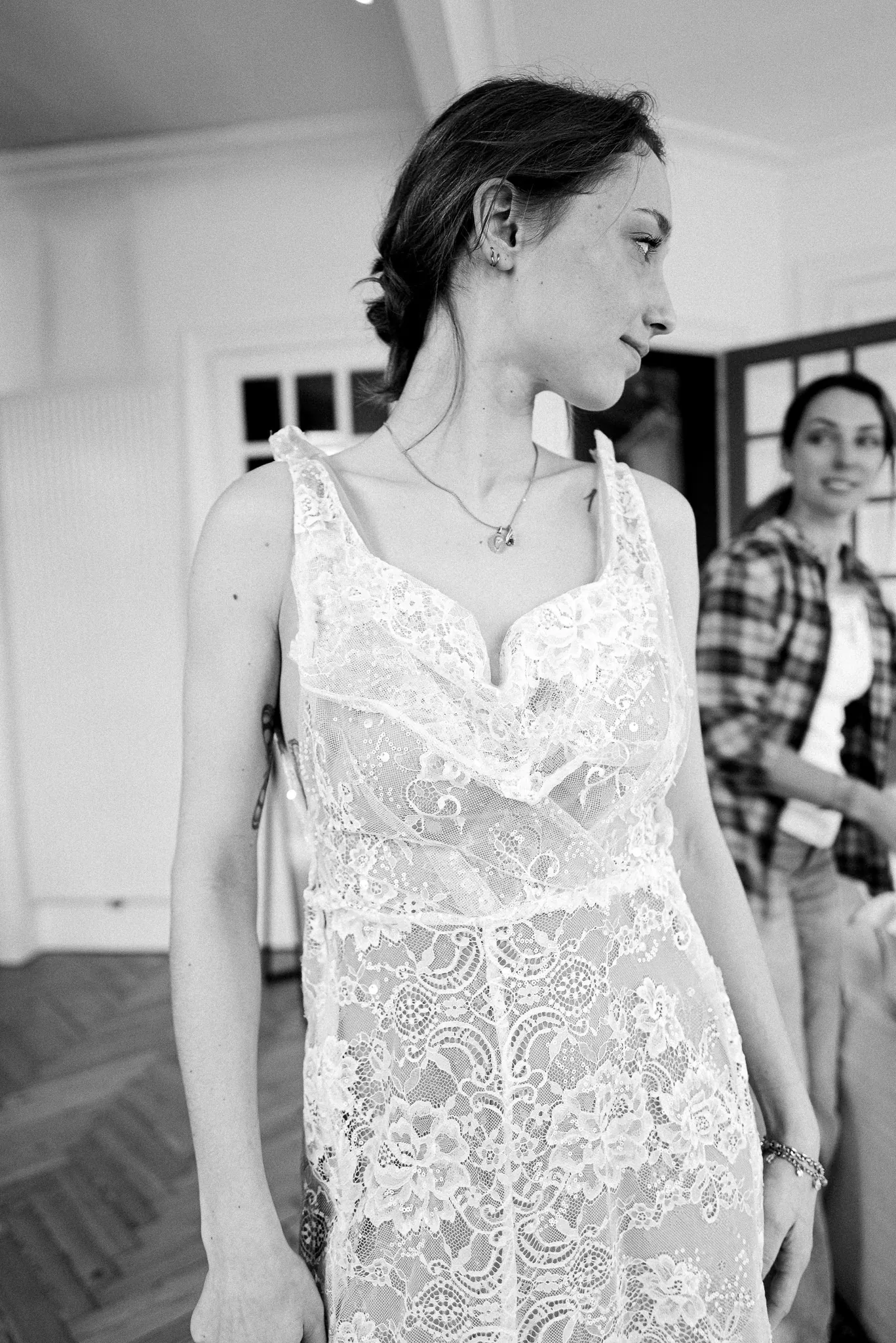 Marie de face dans la robe en dentelle, fines bretelles et décolleté en V, en noir et blanc